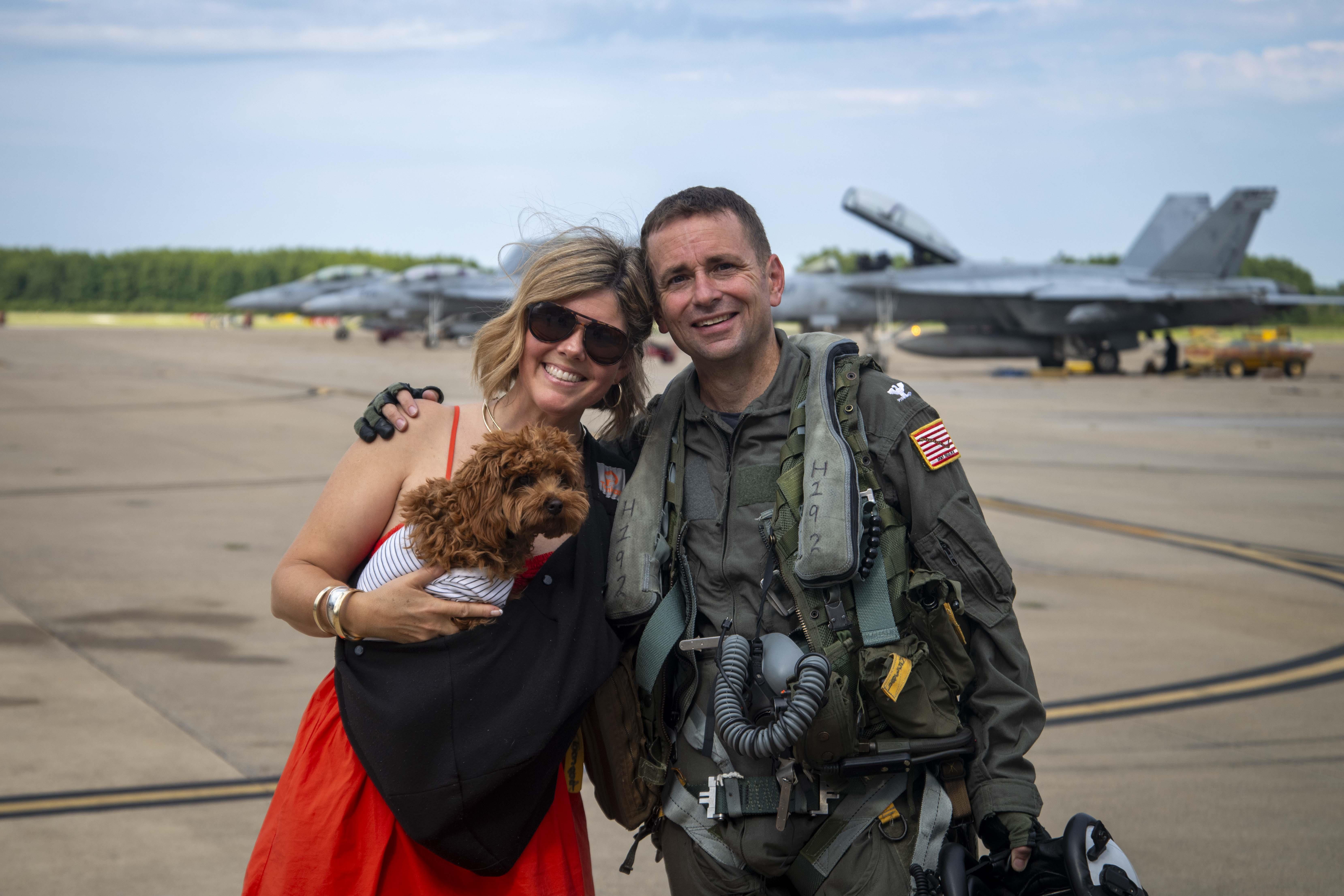 Commanding Officer of NAS Oceana and his wife in front of military planes